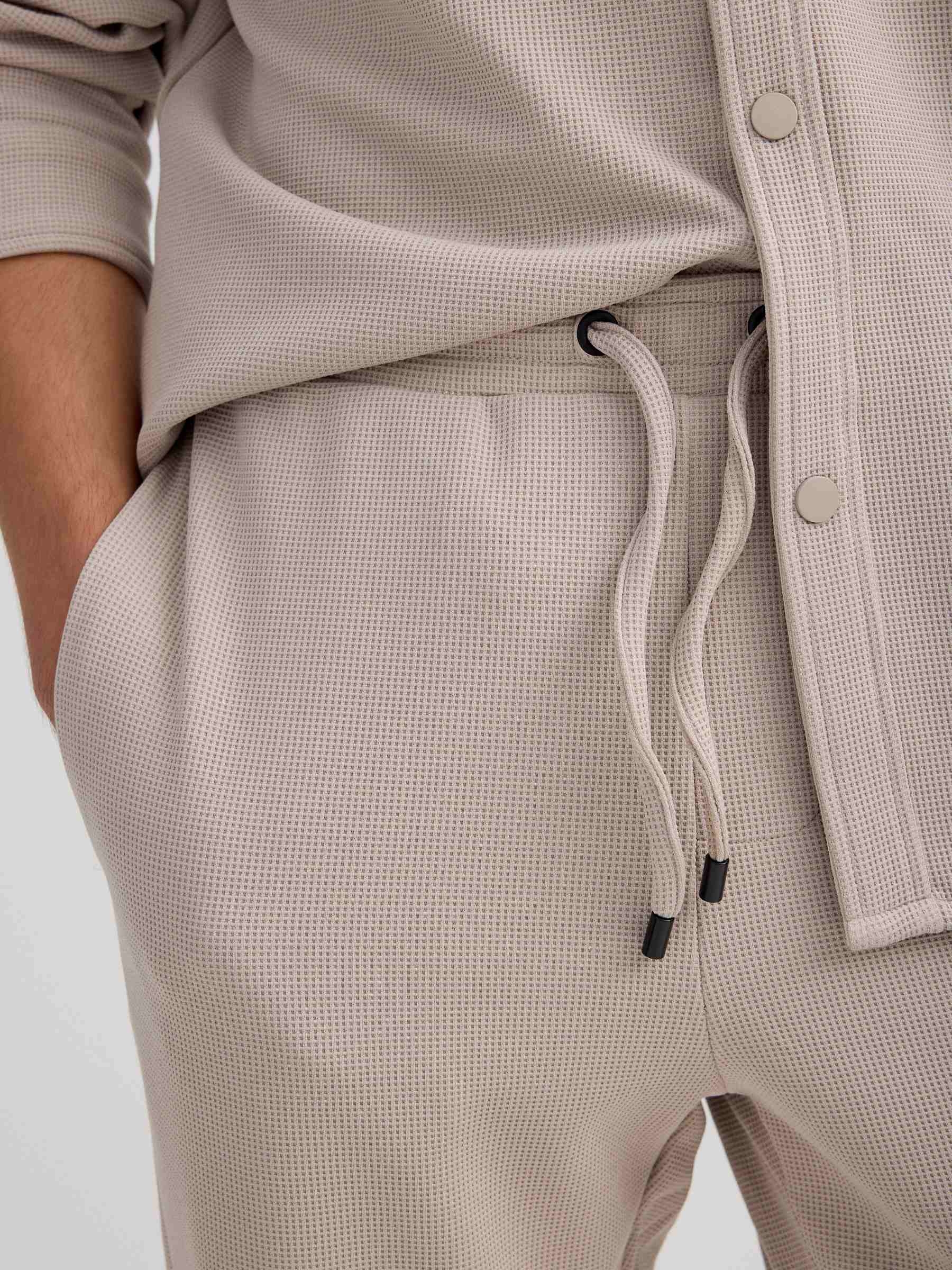 Beige fleece sports jogger raw front view