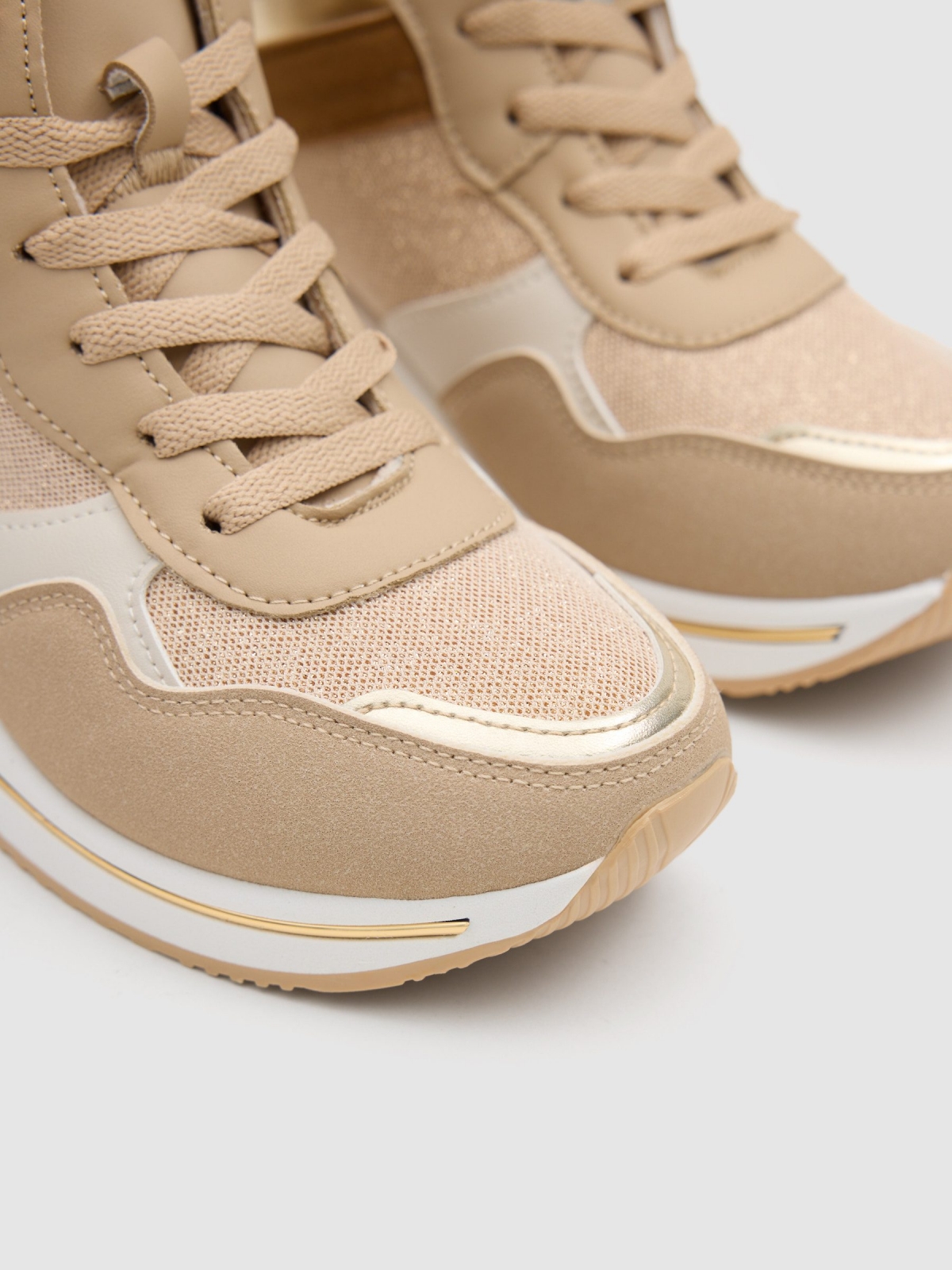 Combined wedge sports shoe sand detail view