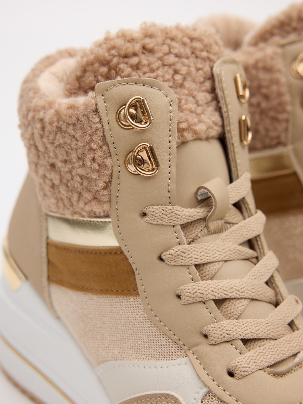 Combined wedge sports shoe sand detail view