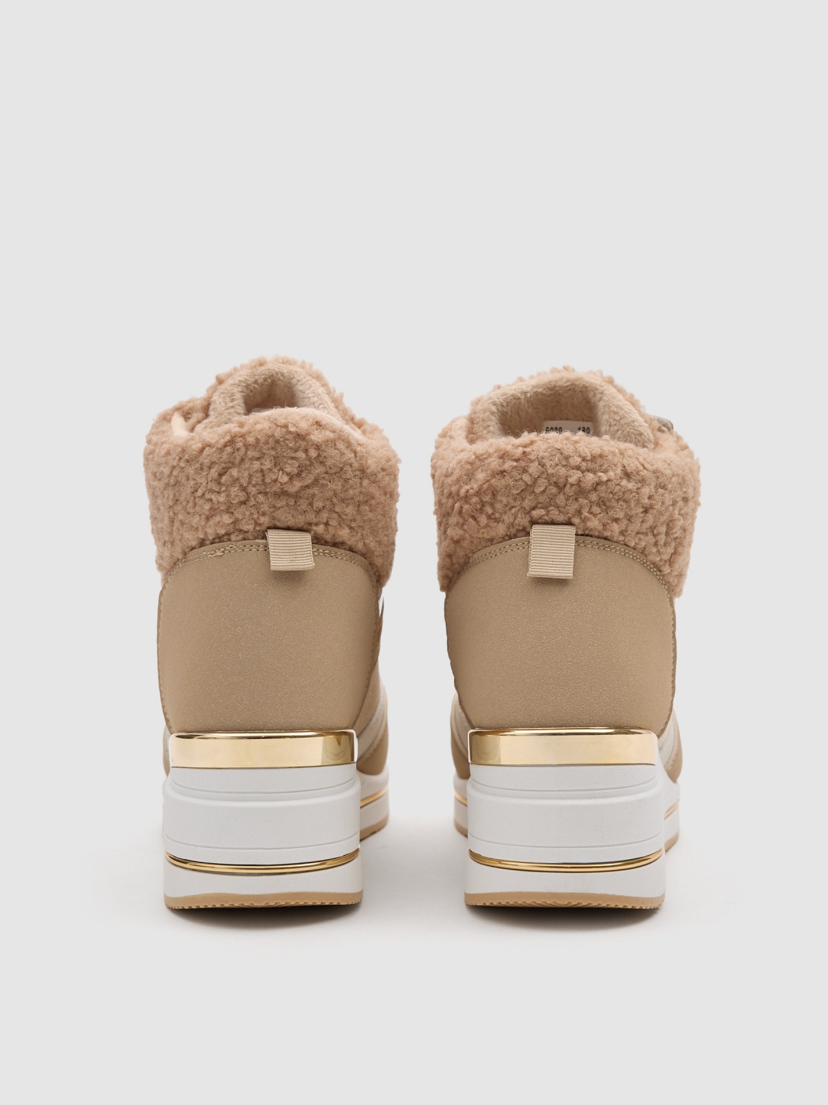 Combined wedge sports shoe sand detail view