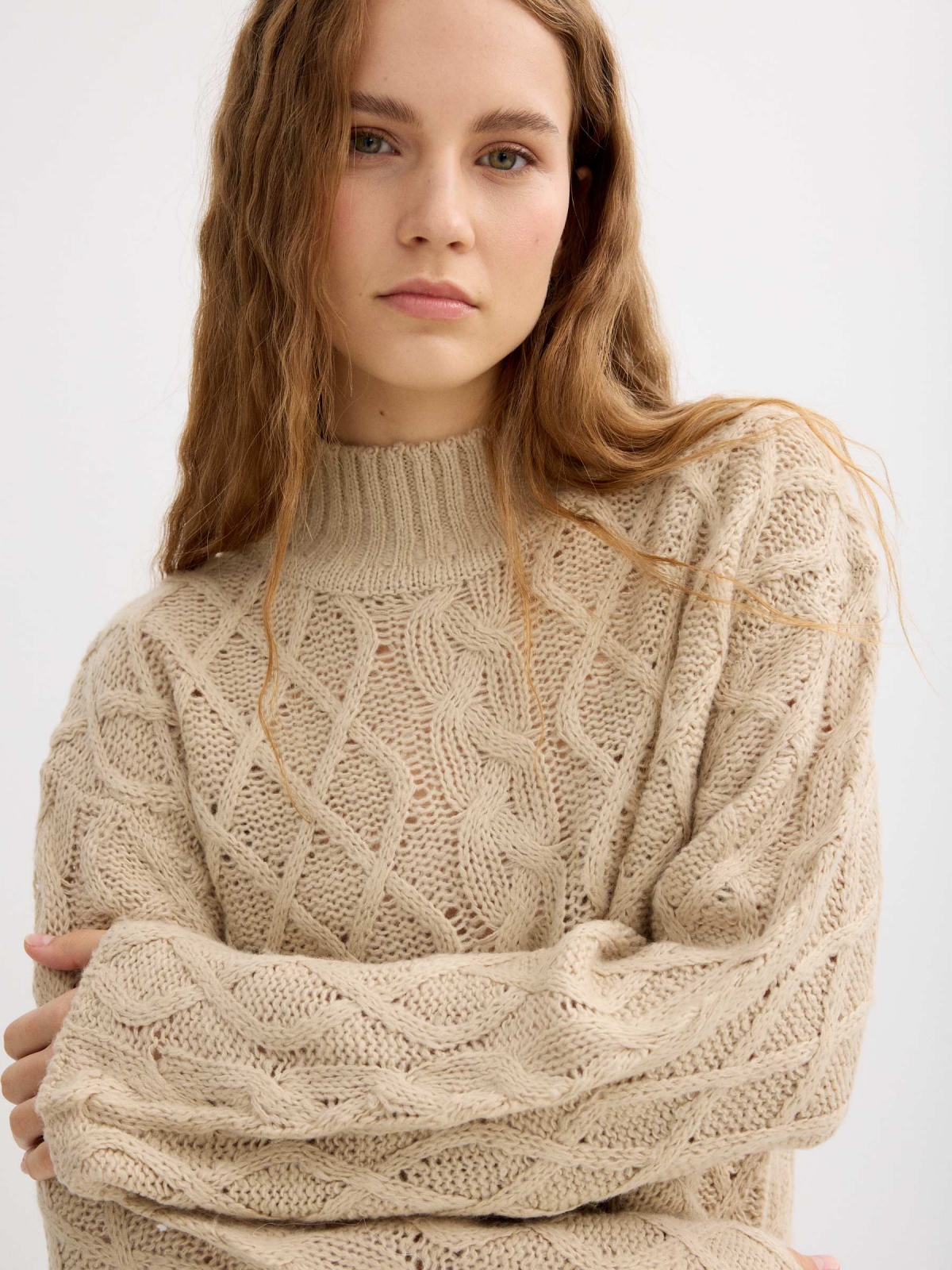Cable knit sweater with a mock neck sand detail view