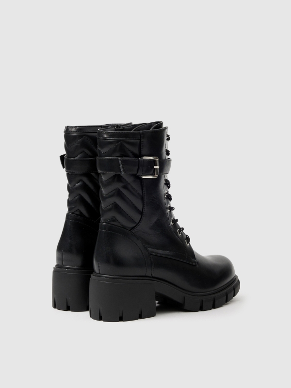 Buckle track sole ankle boot black 45º back view
