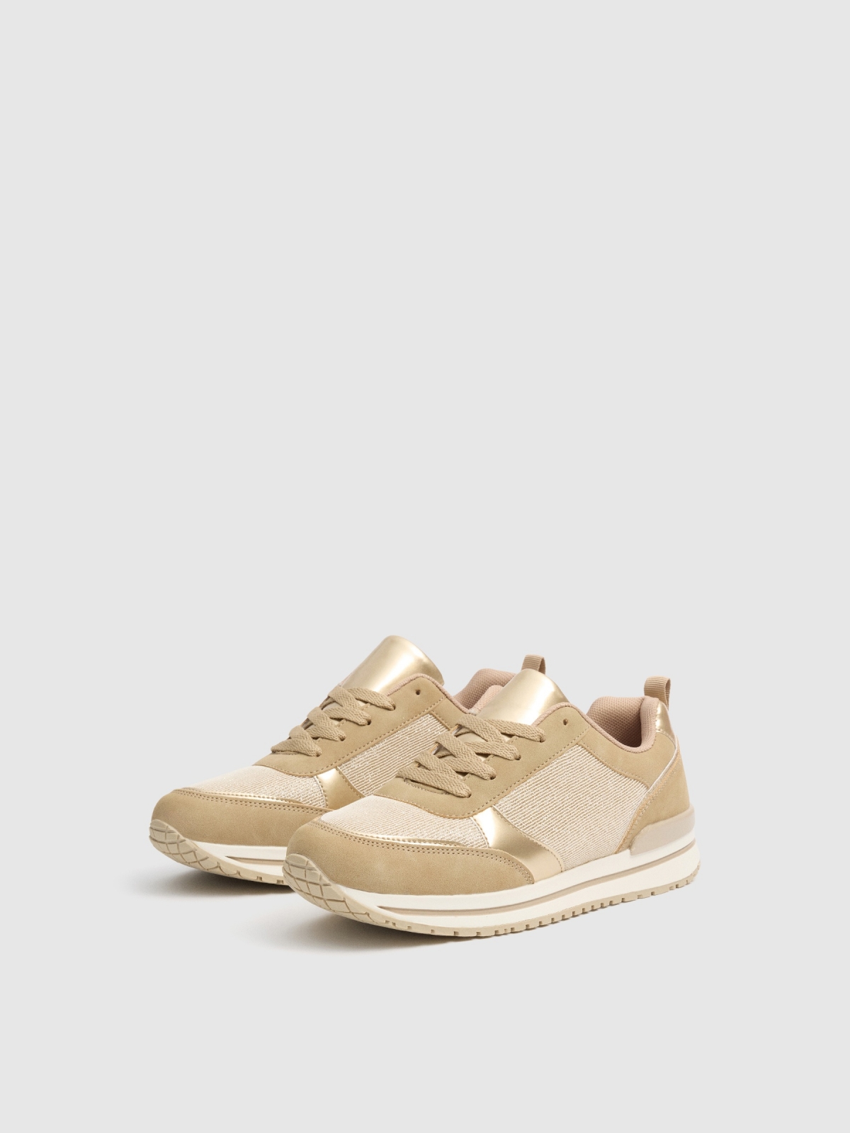 Shiny sneaker shoes sand 45º front view