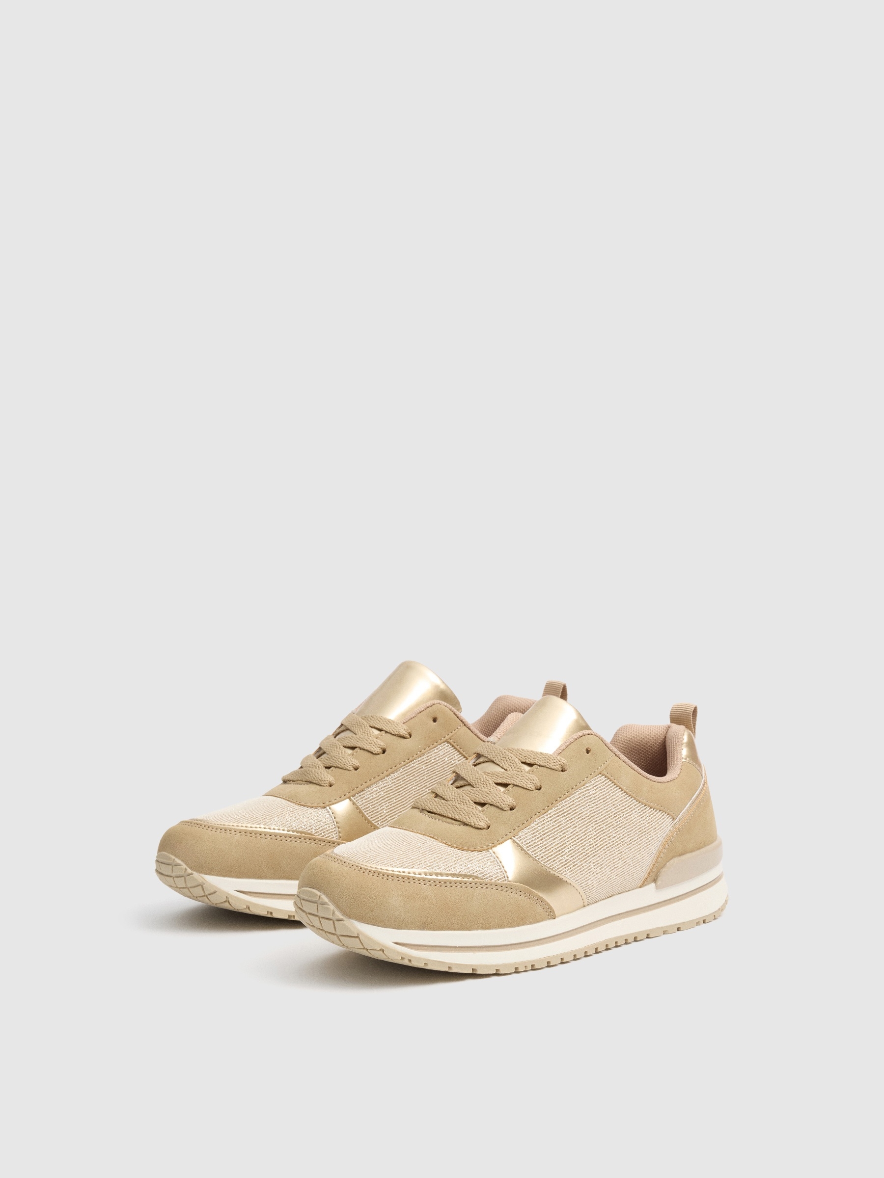 Shiny sneaker shoes sand profile view