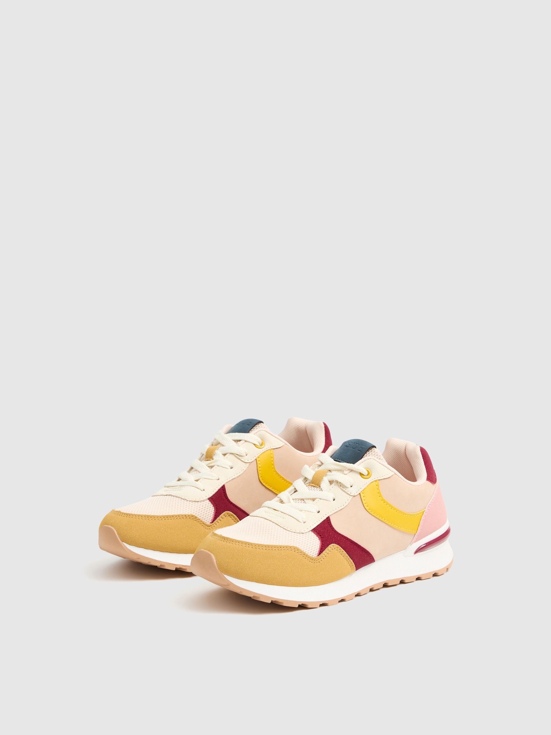 Multi-piece combination sports shoe pastel yellow profile view