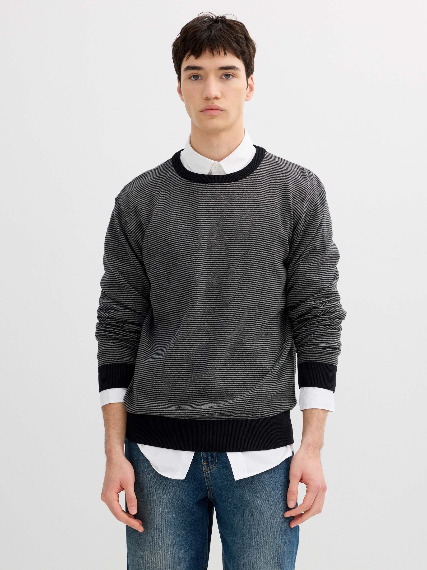 Striped knit sweater with a round neck black middle front view