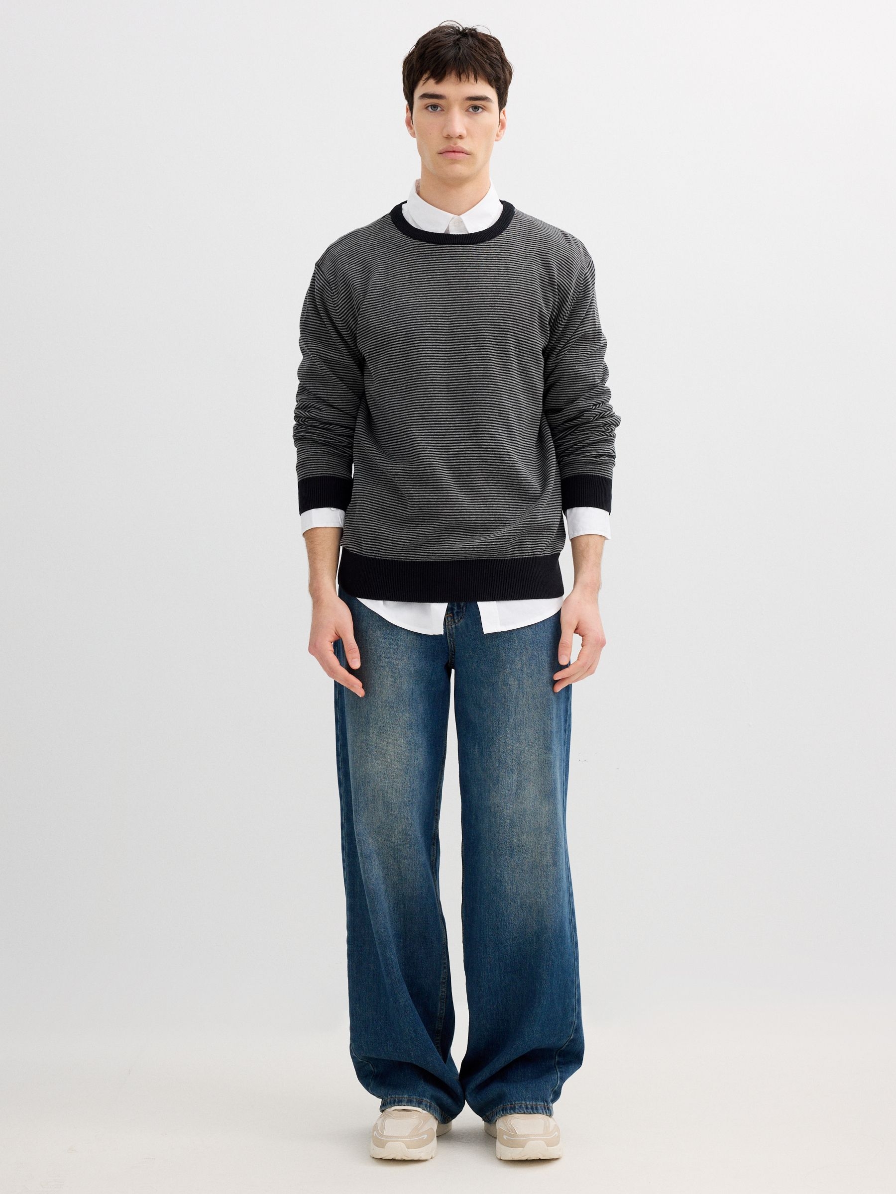 Striped knit sweater with a round neck black middle front view