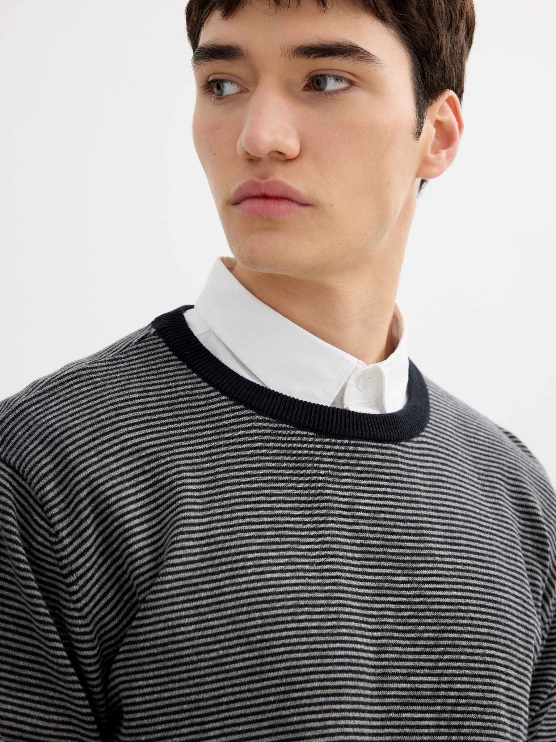 Striped knit sweater with a round neck black middle front view