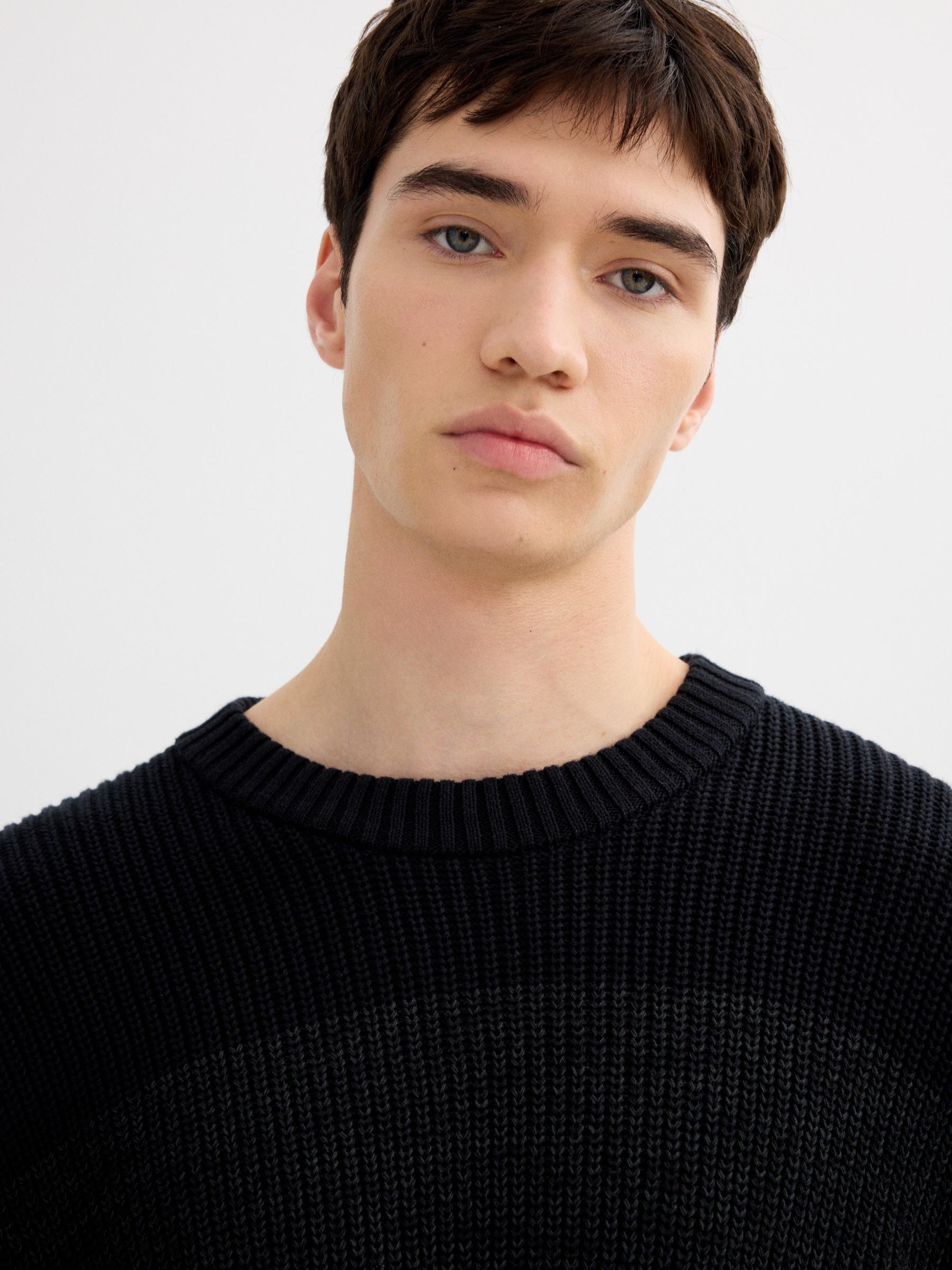 Striped knit sweater with a round neck black middle front view