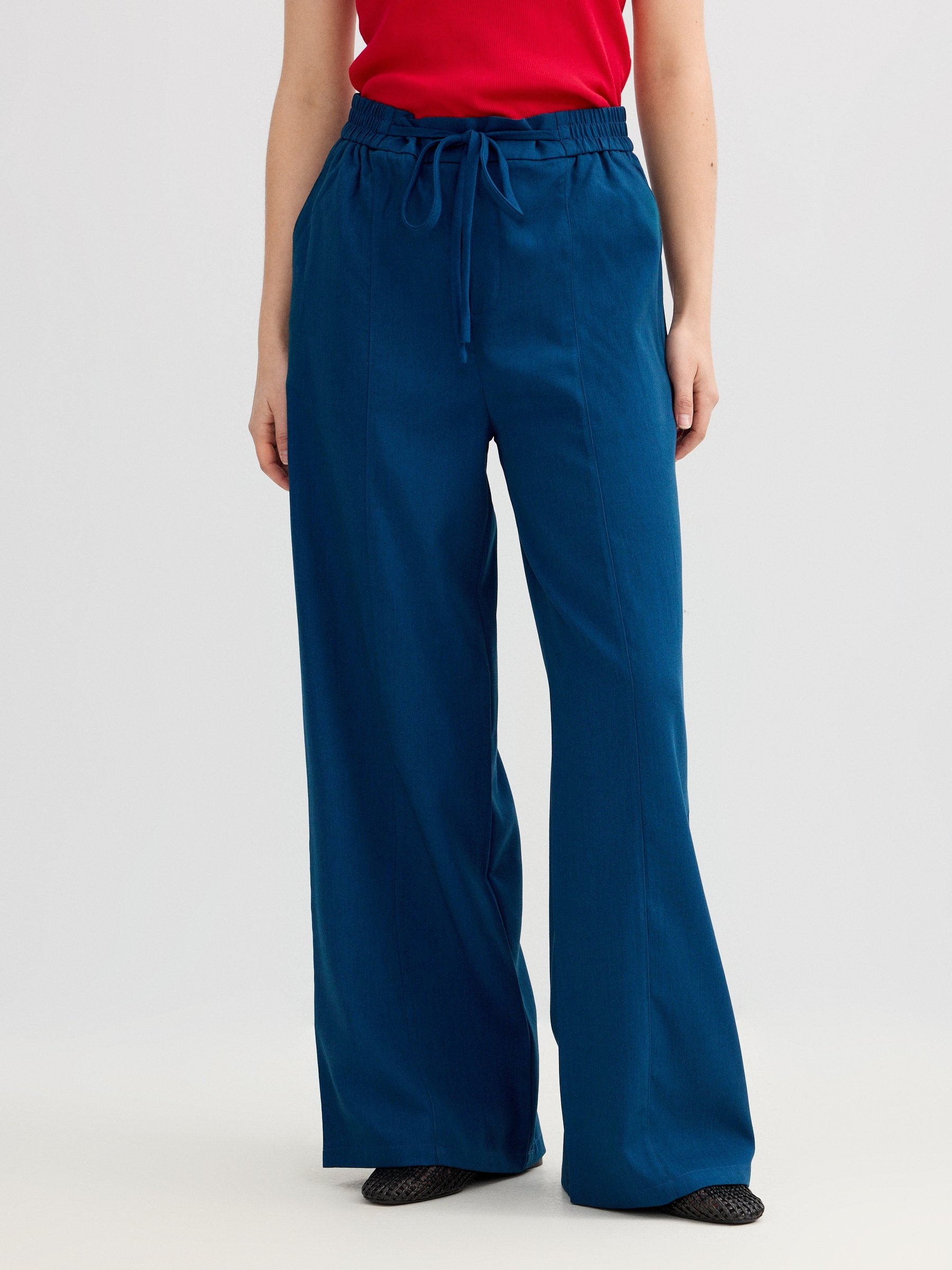 Fluid high-waisted palazzo pants light blue front view