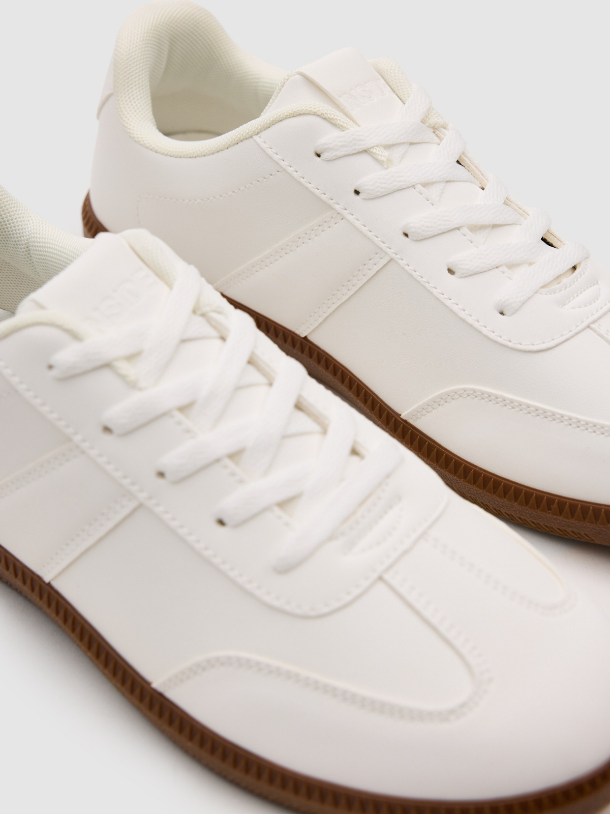 Synthetic leather sports shoes with rubber sole white detail view