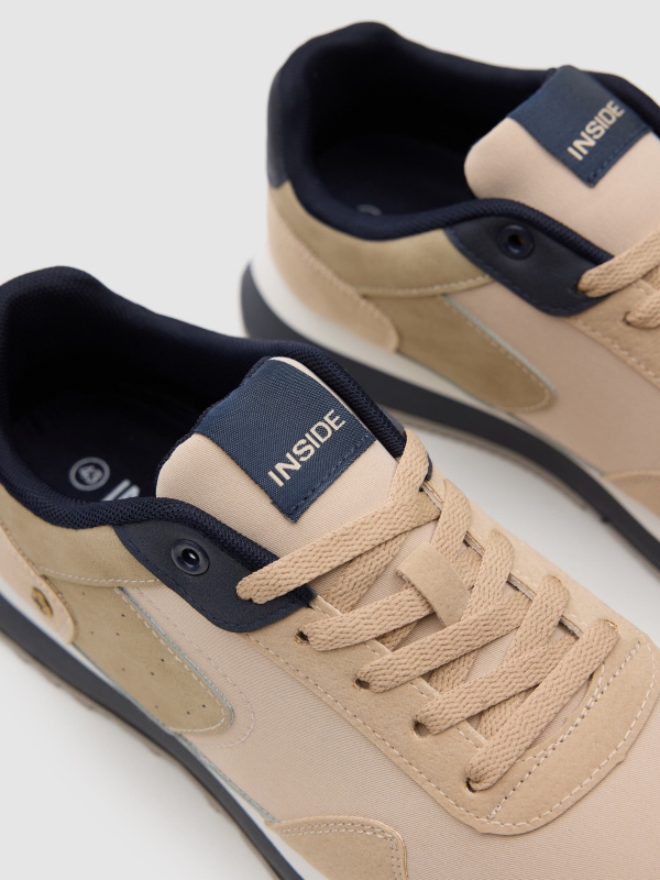 Nylon and rubber running shoes sand detail view