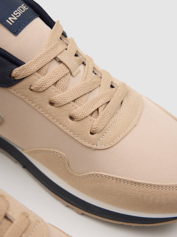 Nylon and rubber running shoes sand detail view