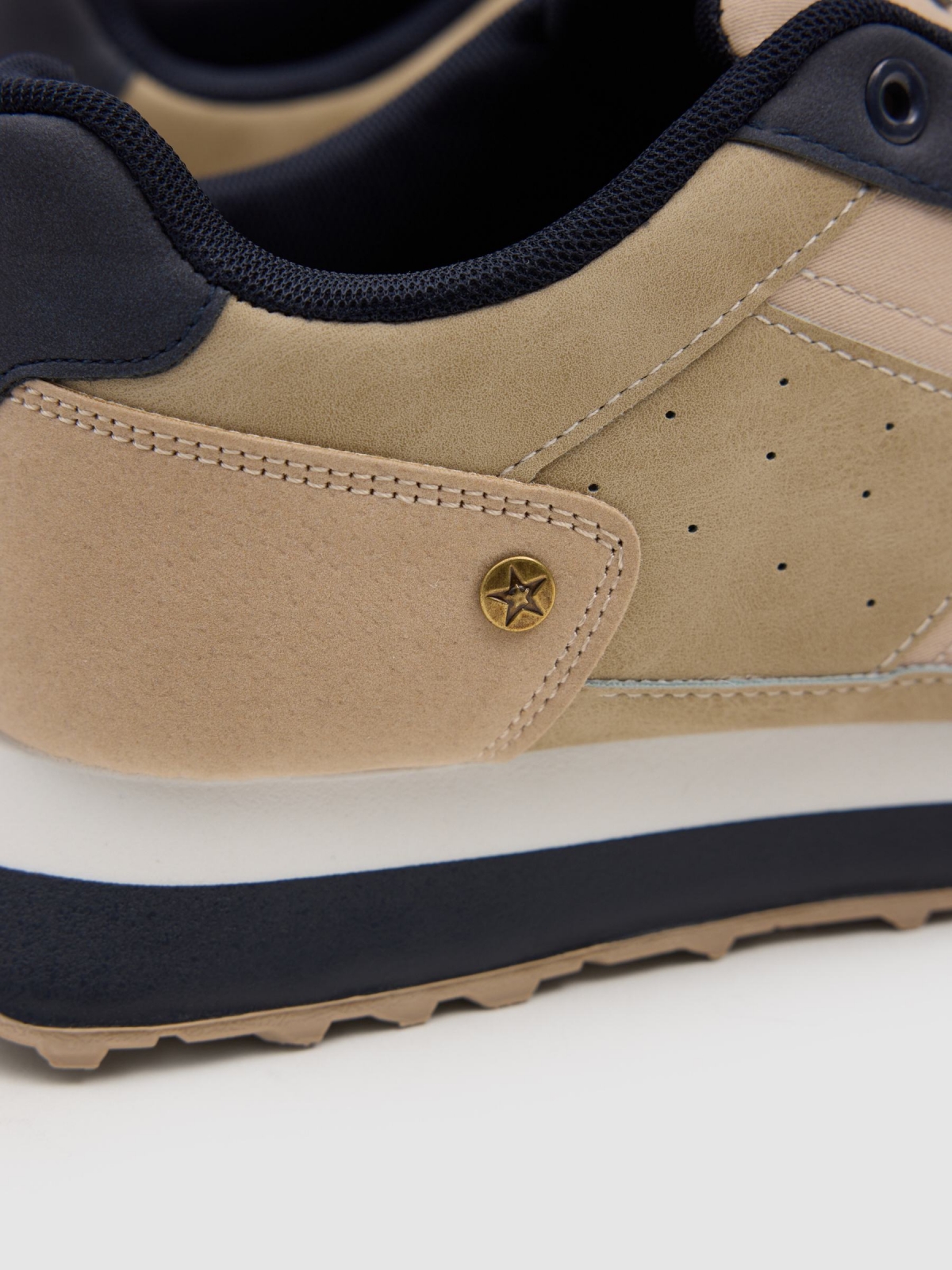 Nylon and rubber running shoes sand detail view