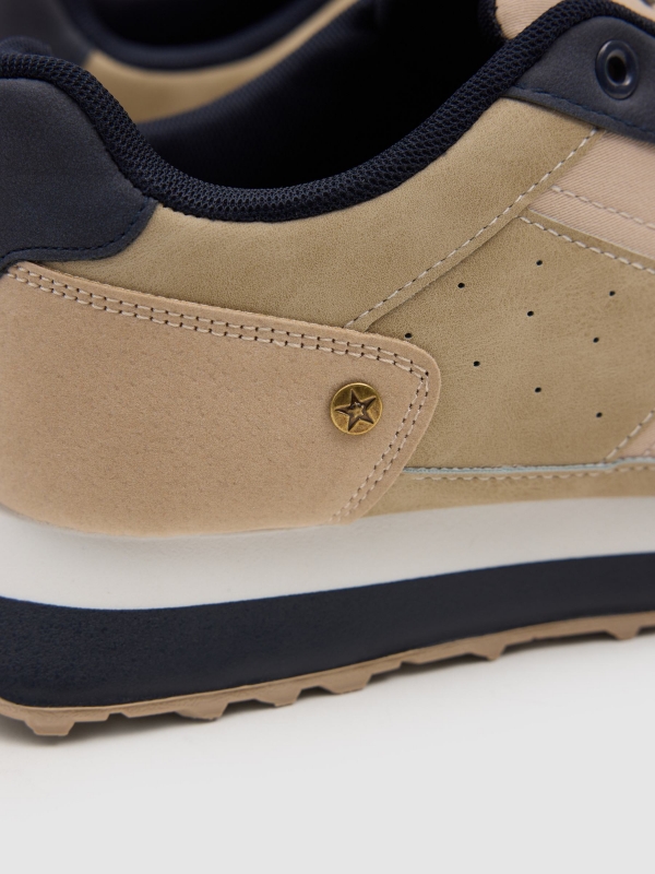 Nylon and rubber running shoes sand detail view