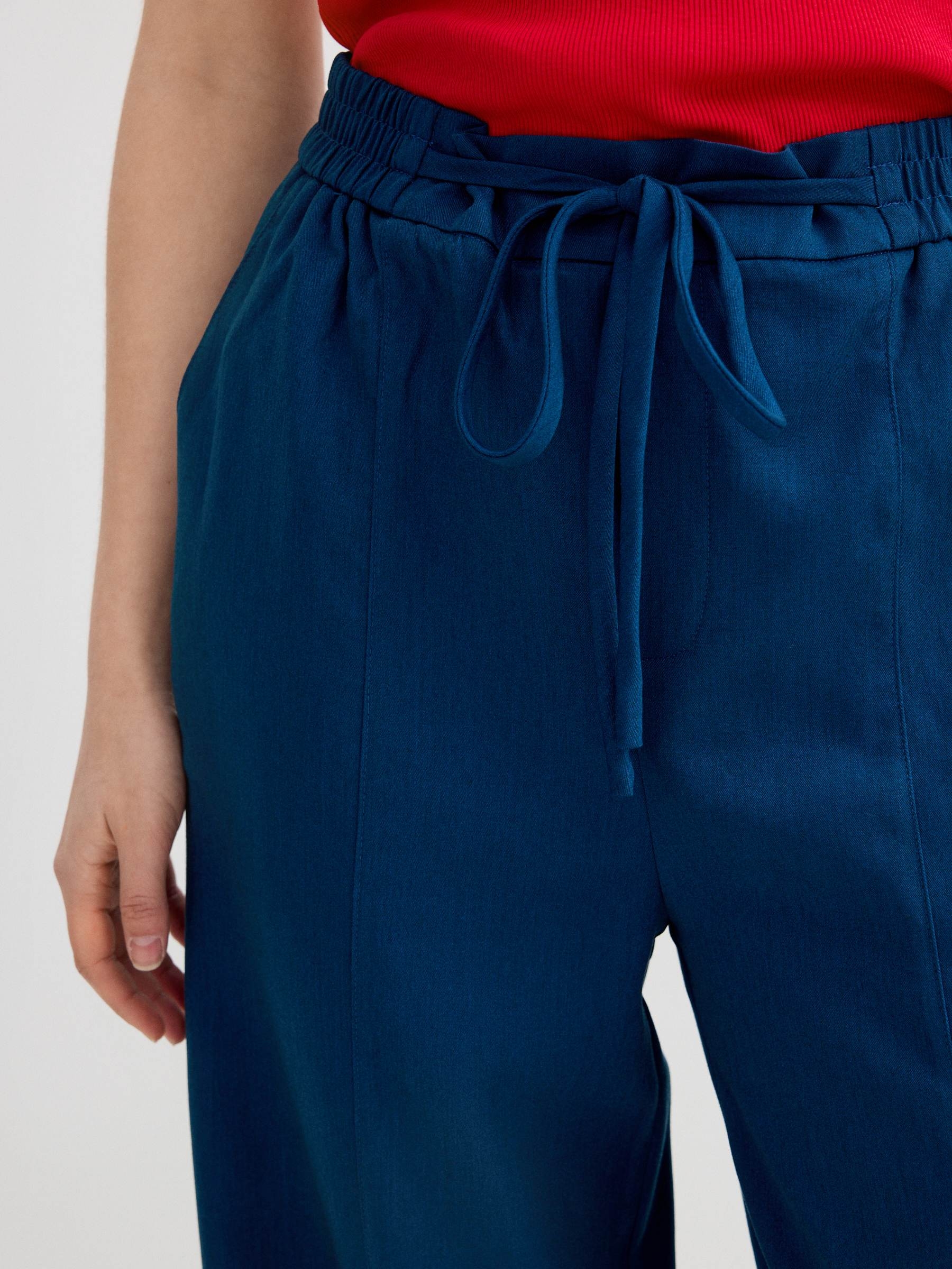 Fluid high-waisted palazzo pants blue front view