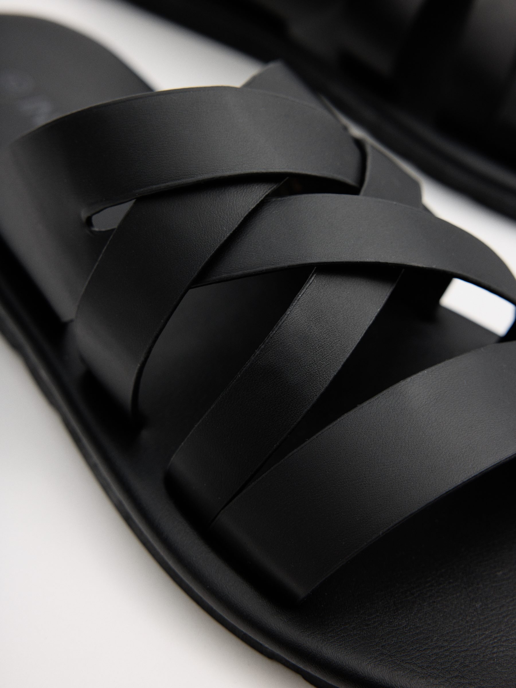 Cross-strap sandals black profile view