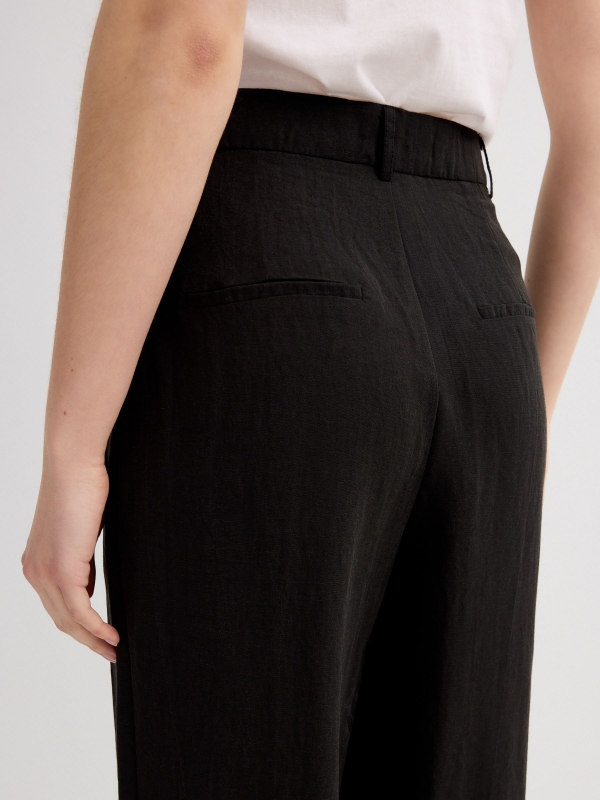 Asymmetric wide-leg pleated pants black detail view