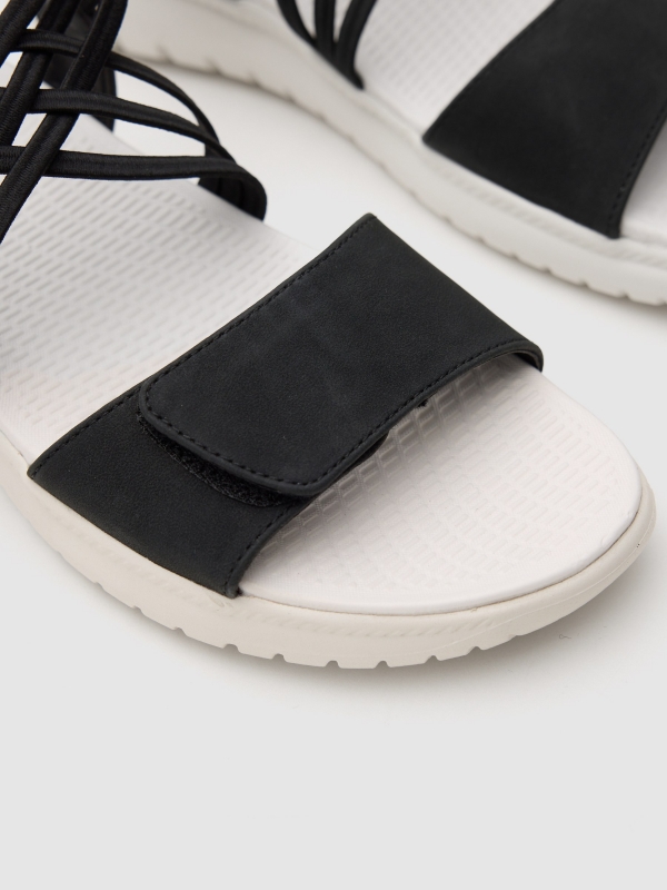 Flat sandal with crossed faux leather straps black detail view