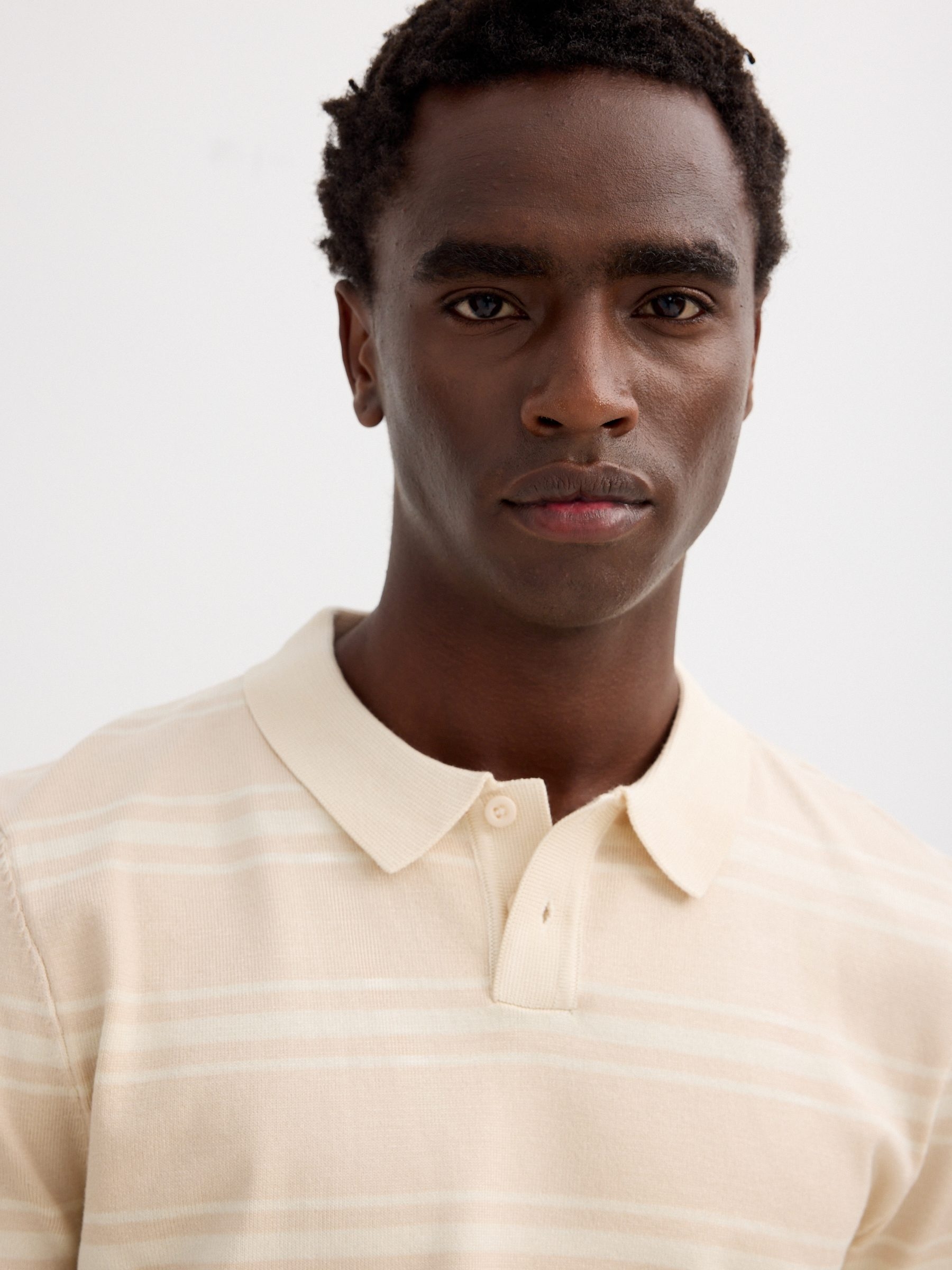 Striped knit polo shirt with buttons raw middle front view