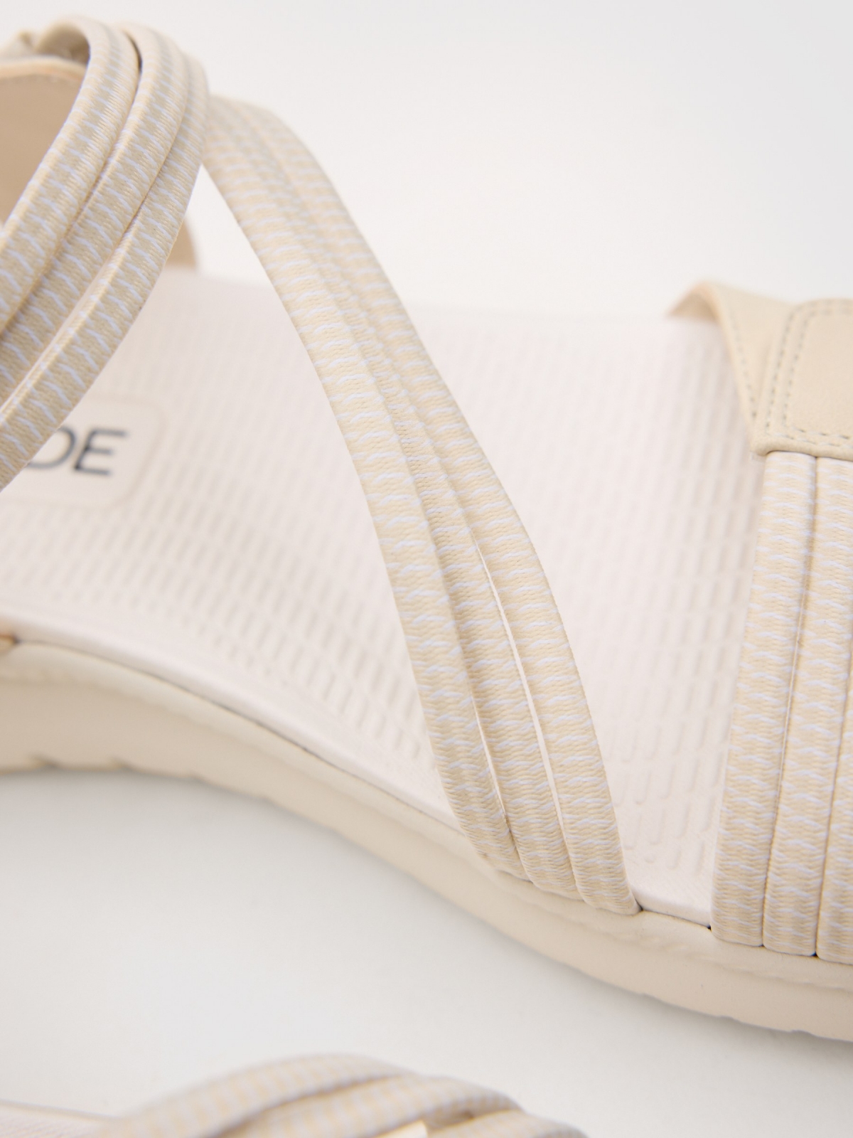 Crossed faux leather sandal with velcro beige detail view