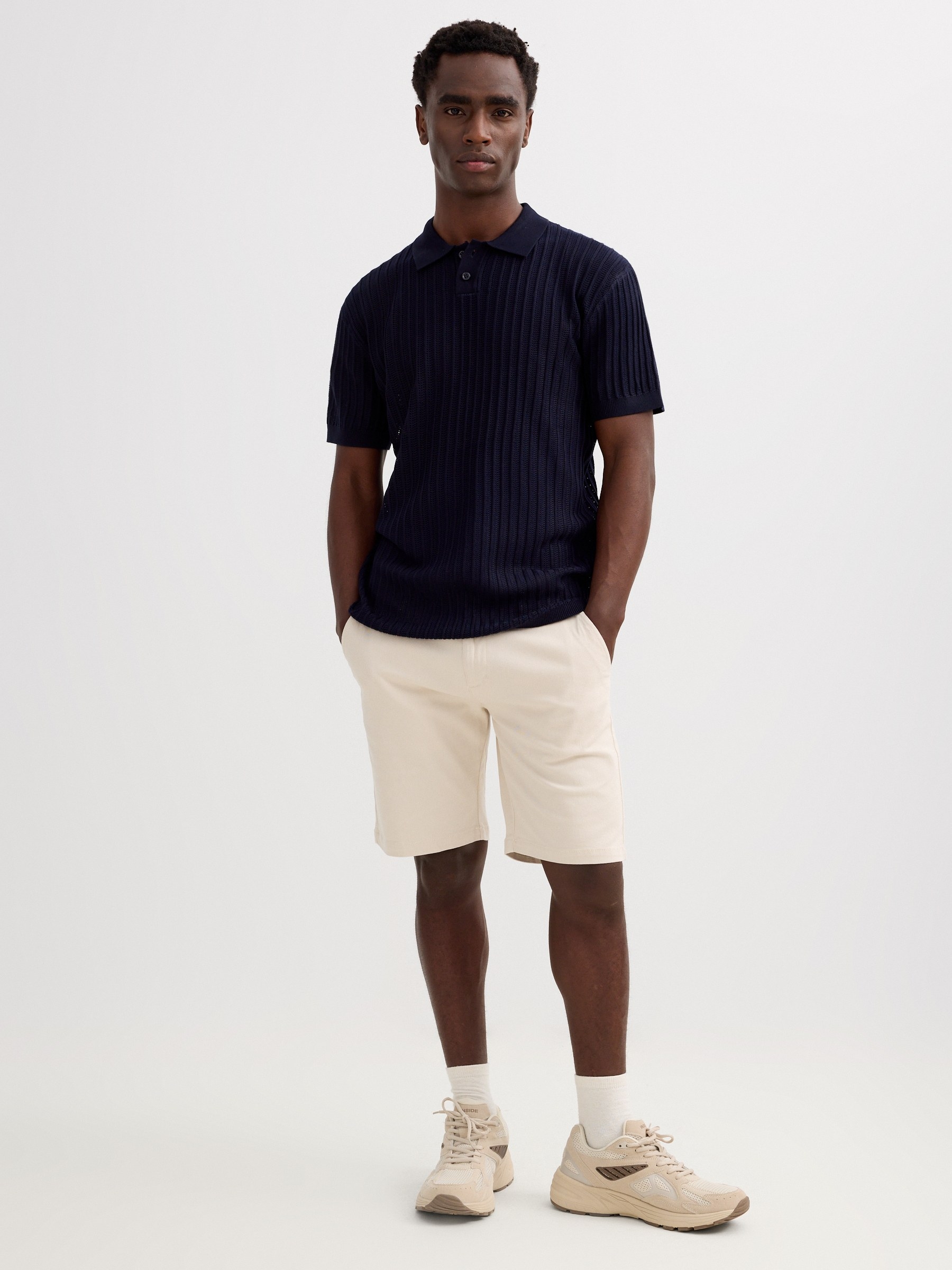 Plain knit polo shirt with buttons green middle front view