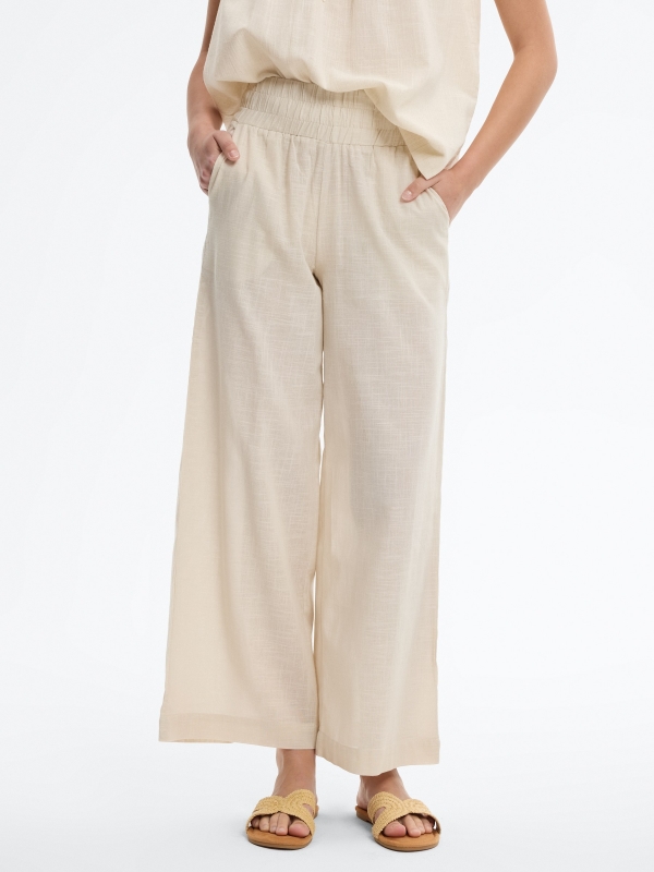 Pantalón palazzo lino elástico blanco roto vista media frontal