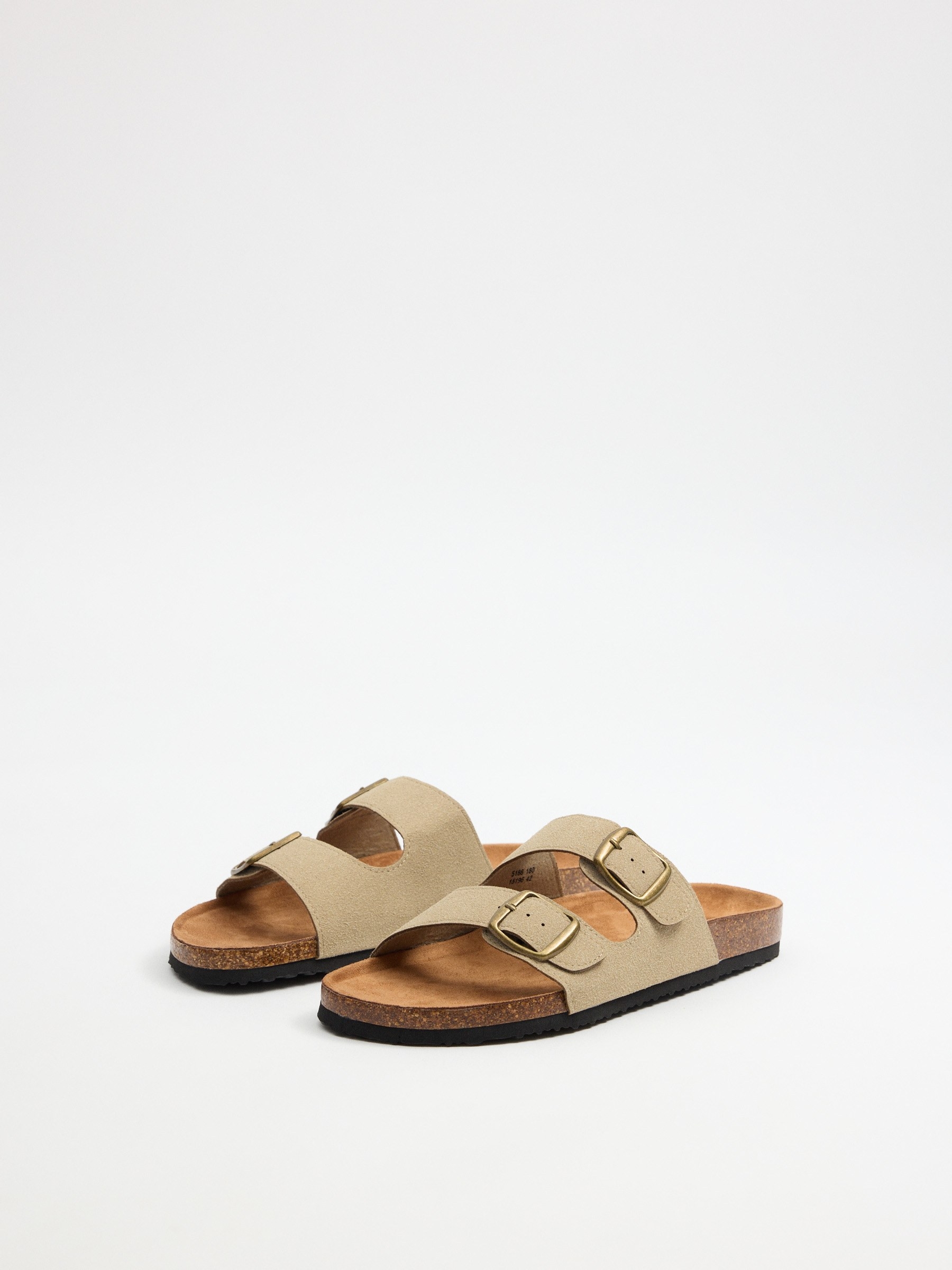 Flat sandal with double strap buckle sand. sand