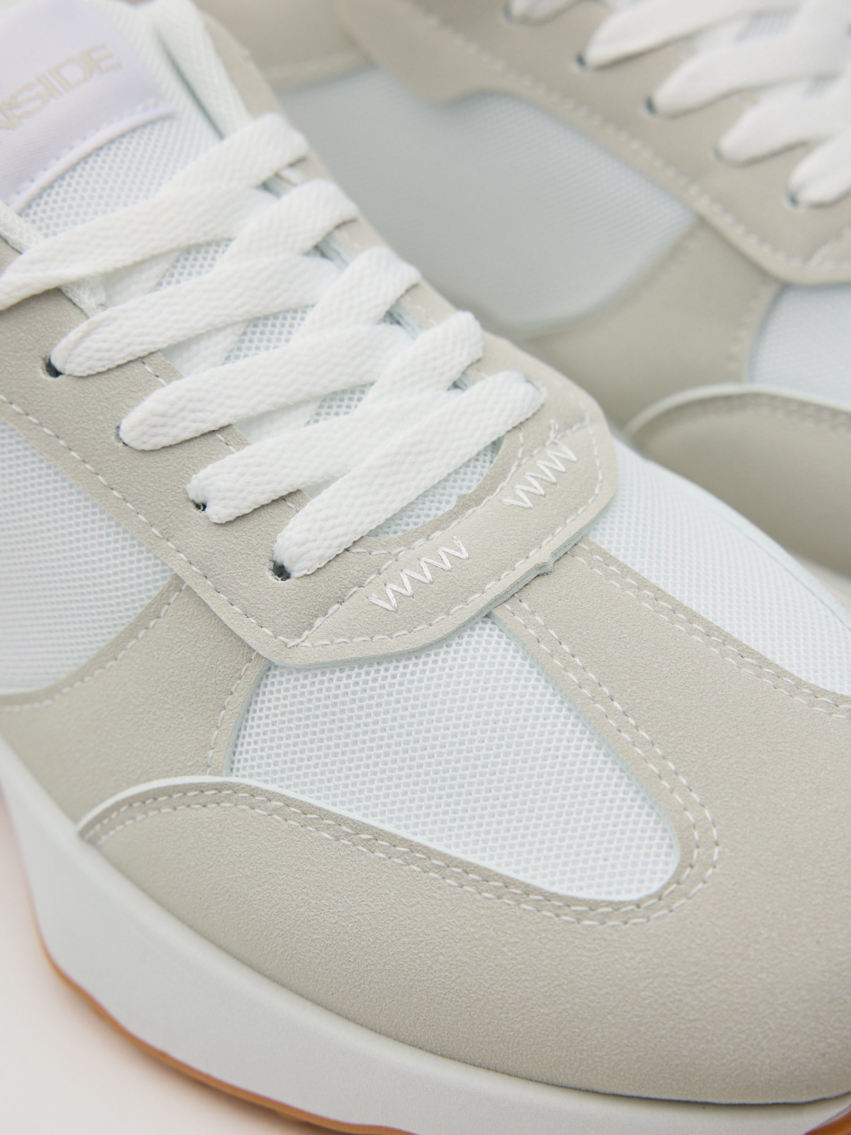 Nylon and rubber running shoes white detail view