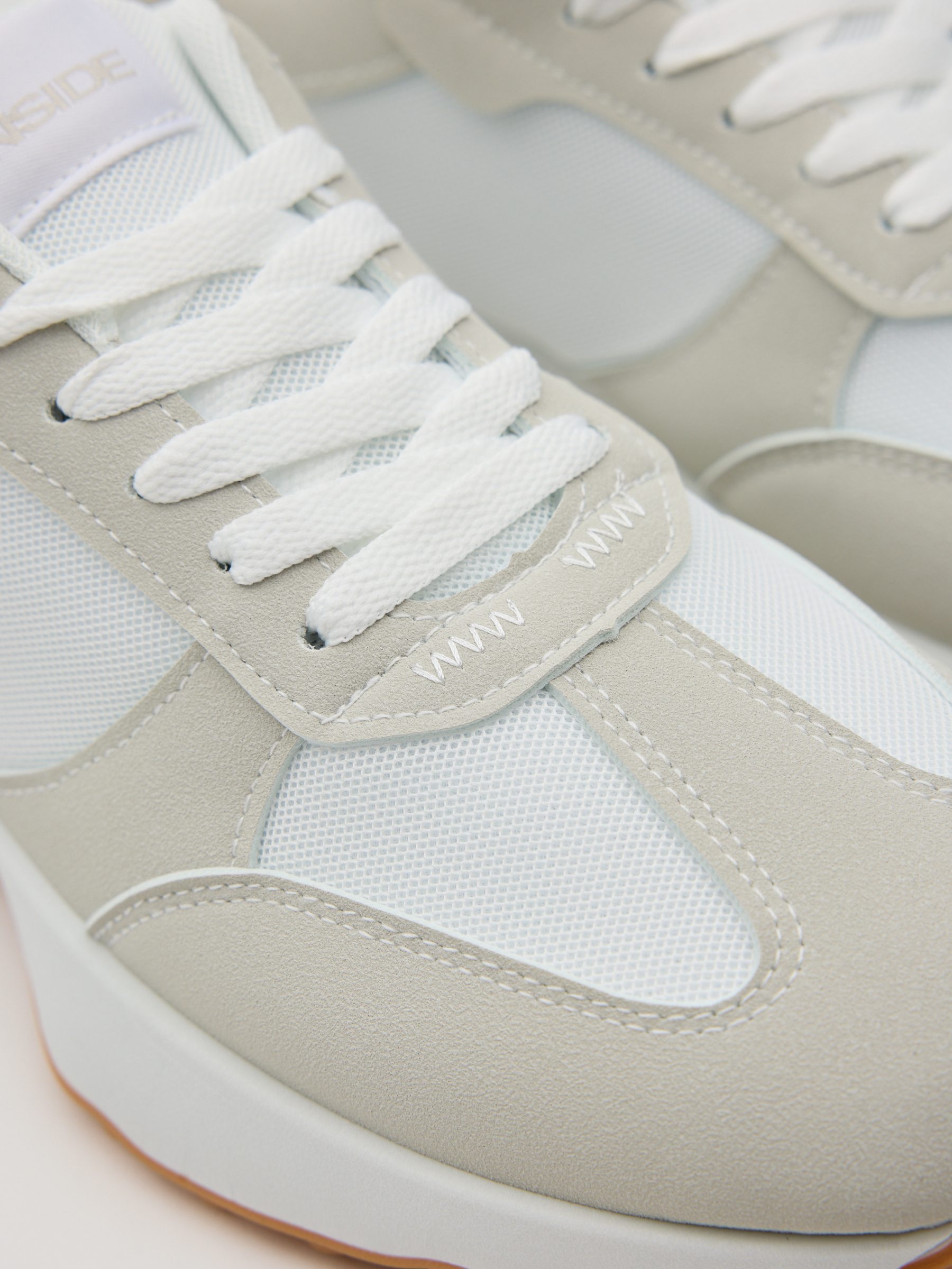 Nylon and rubber running shoes white