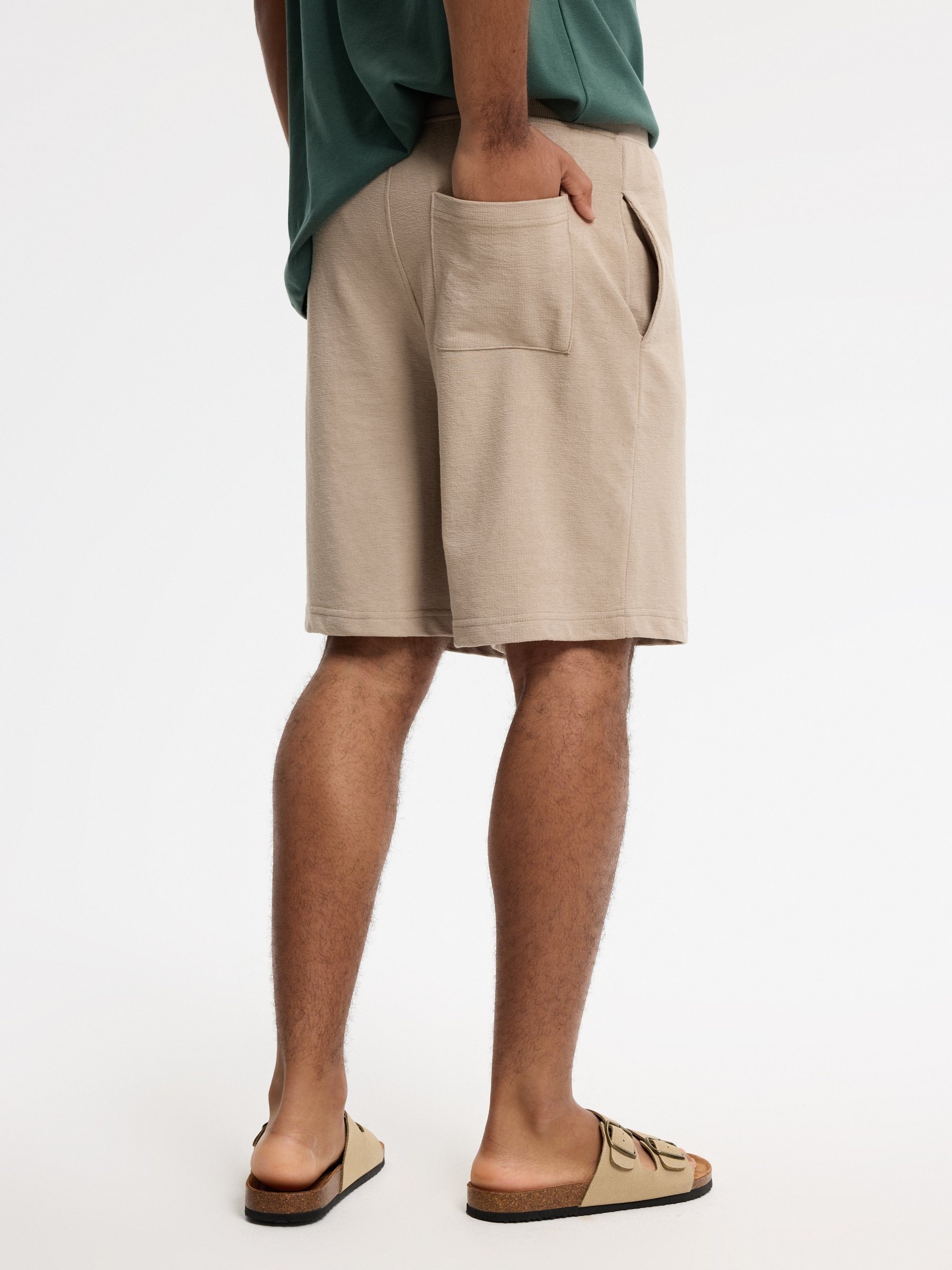 Bermuda deportiva de felpa beige vista media frontal