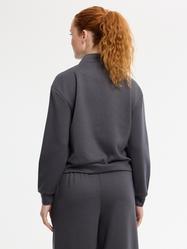 Soft zip-up jacket with high collar dark grey middle back view