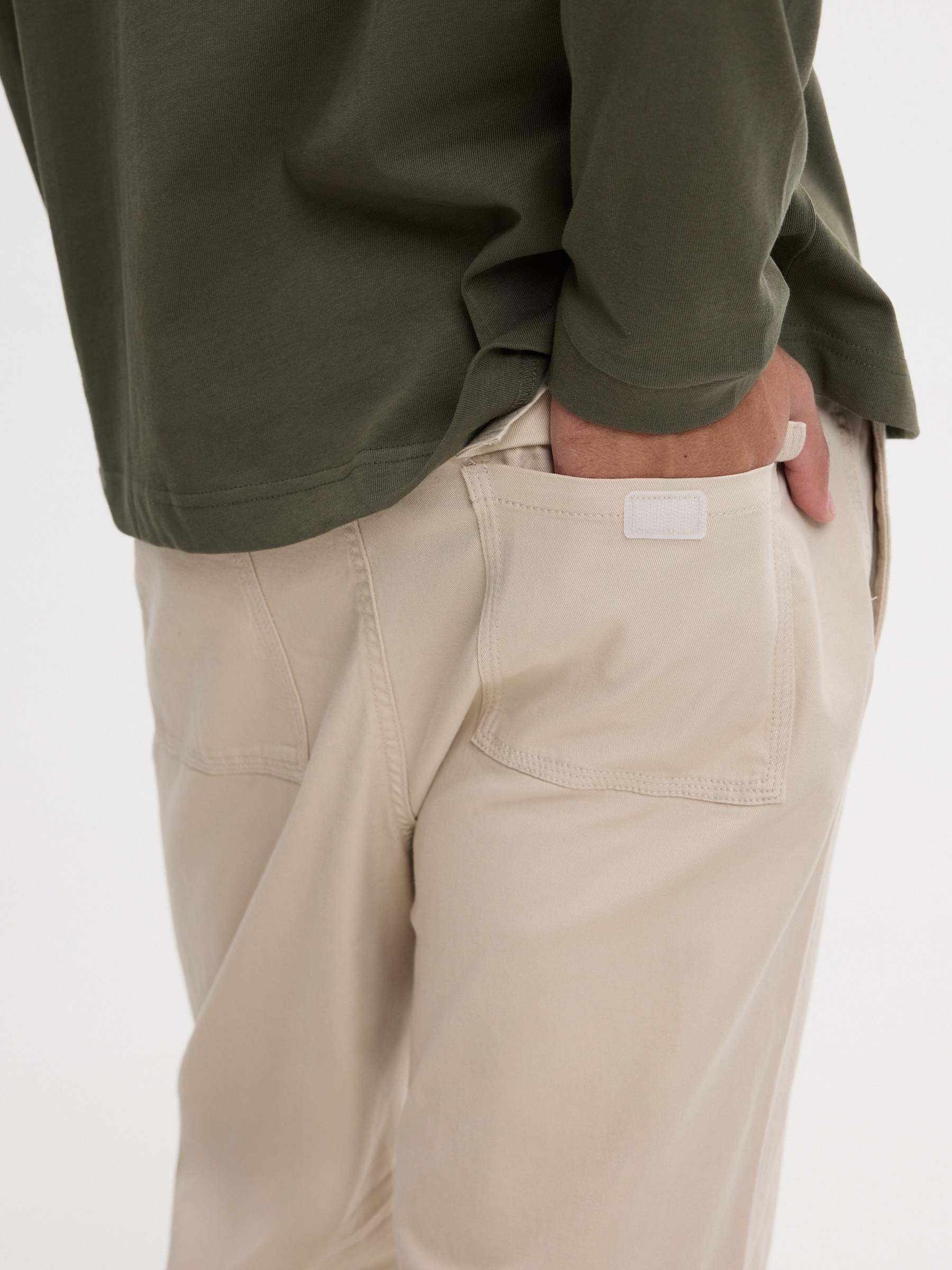 High-waisted slim-fit chinos beige front view