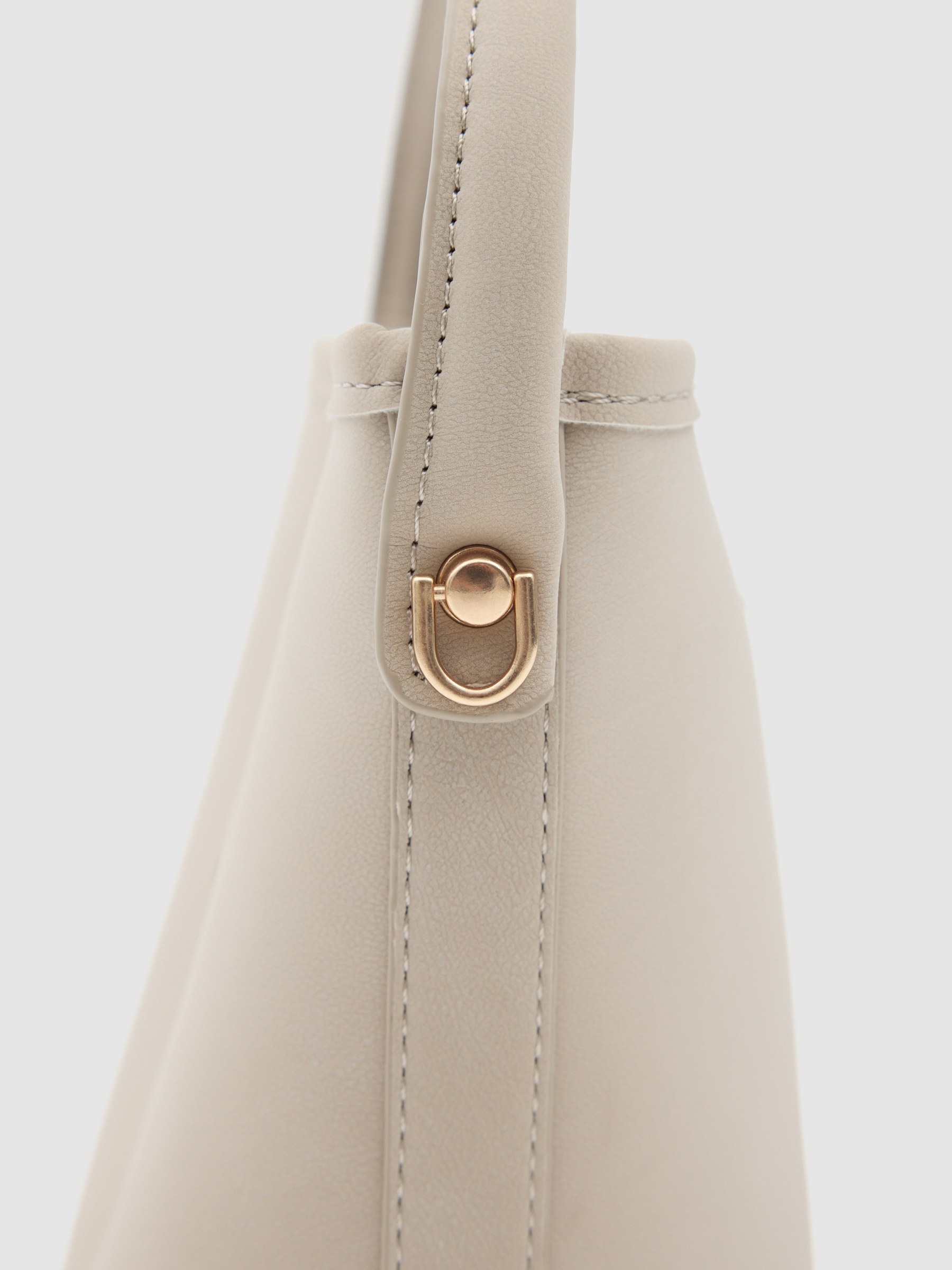 Shoulder bag with gold buckle beige front view