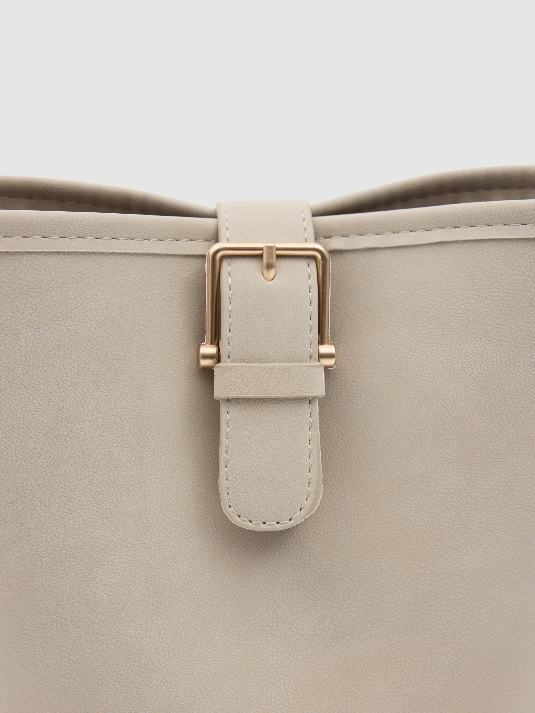 Shoulder bag with gold buckle beige front view