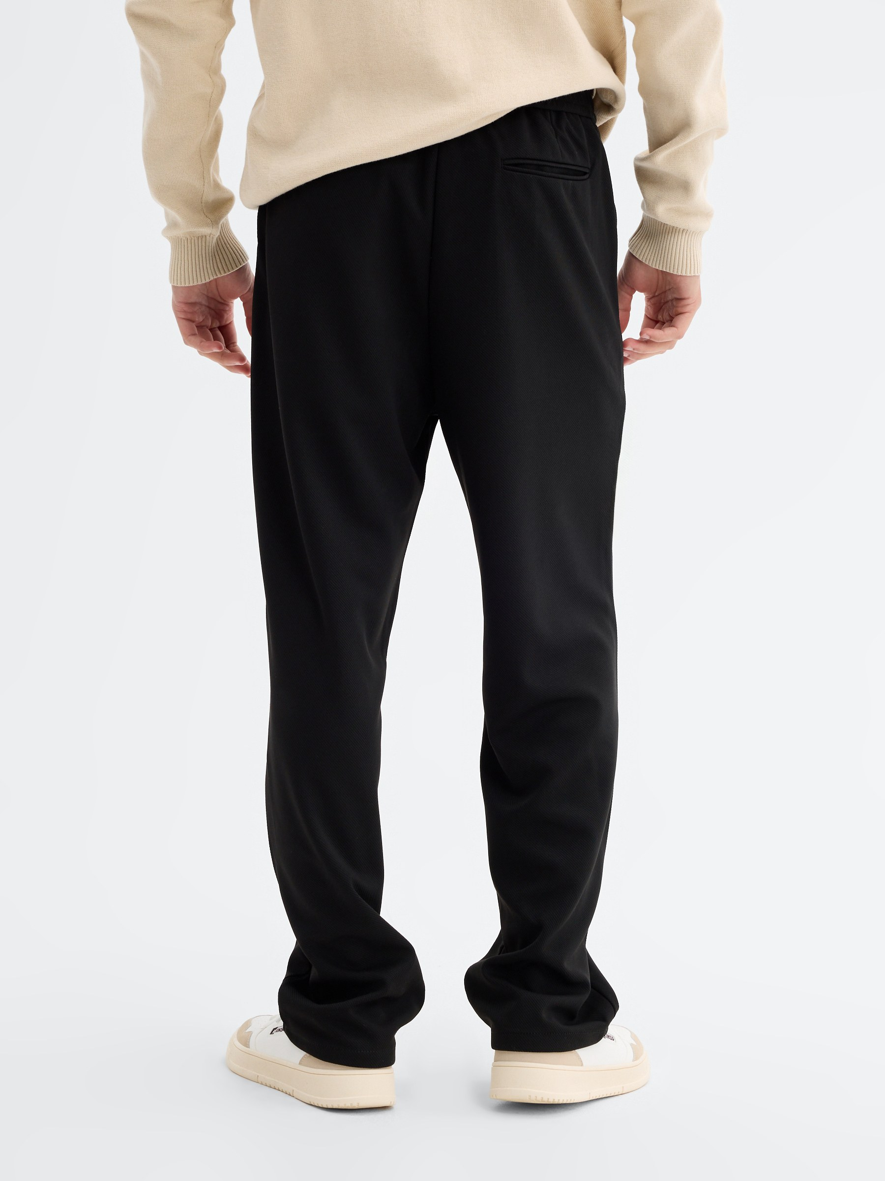 High-waisted polyester chino pants black front view